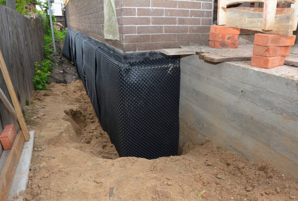 Happy homeowners after waterproofing job in Melrose